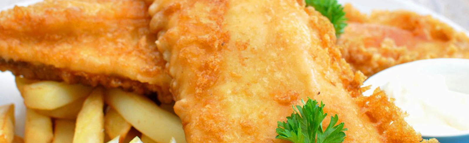 Matte gouache painting of battered fried fish and golden fries on a warm plate, with soft amber and cream tones, inviting and hearty mood